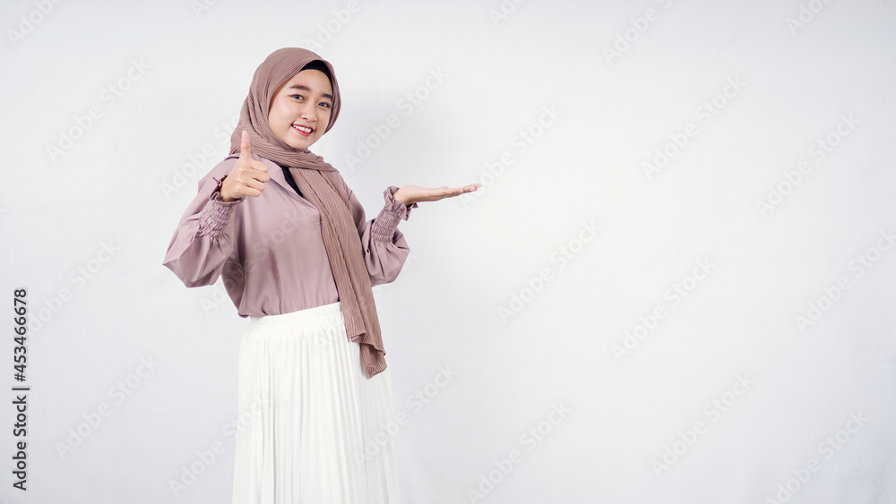 Asian hijab woman pointing blank on left side and okay isolated on white background Asian hijab woman pointing blank on left side and okay isolated on white background