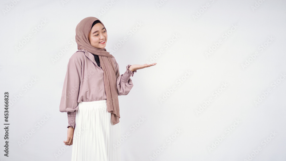 Asian woman wearing hijab pointing blank space beside isolated on white background Asian woman wearing hijab pointing blank space beside isolated on white background