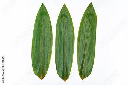 Three bamboo leaves for serving Japanese food on white background.