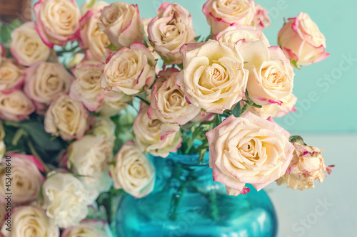 Still life with a fresh roses in a vase. Pastel tonality. Soft focus. 