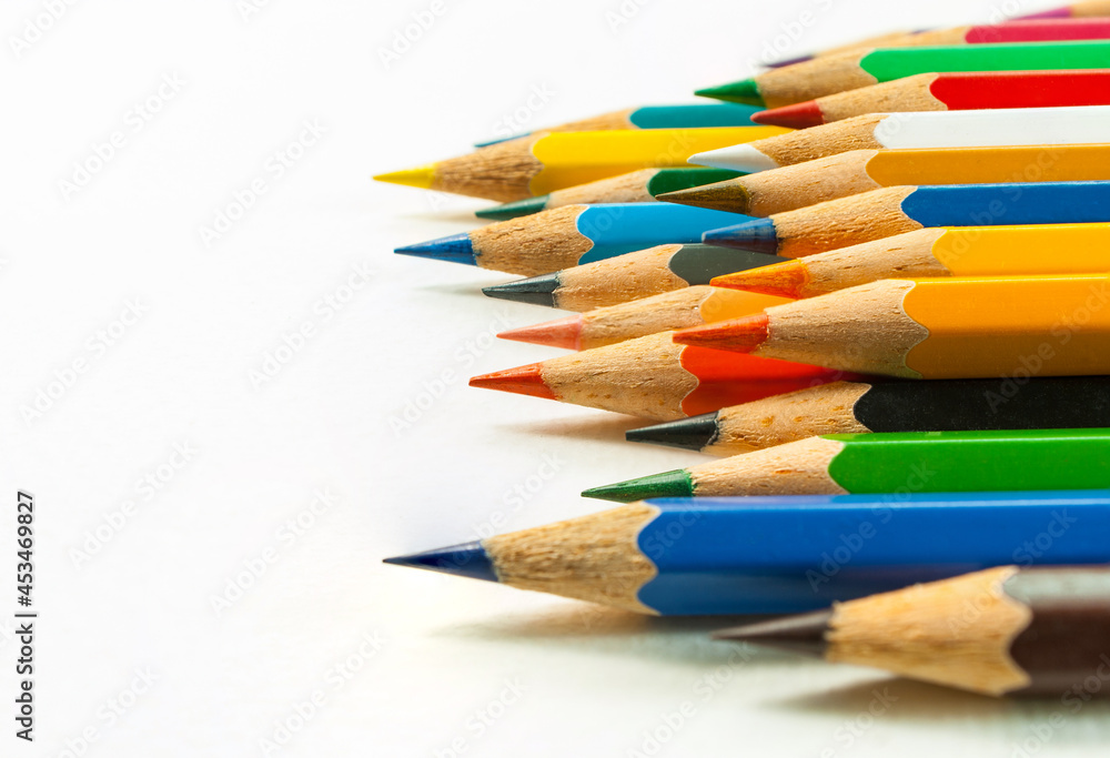 Fototapeta premium Right side view of various colored pencils. placed isolated on white background and colored pencils in close-up.Concept art Text copy space and office