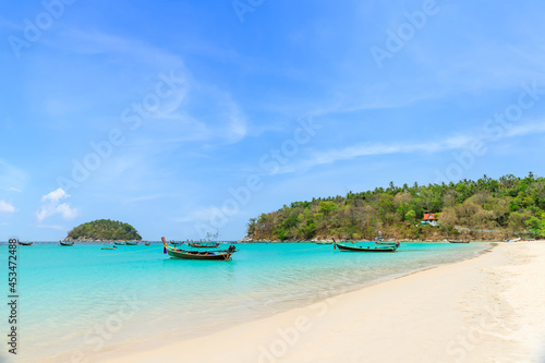 Kata Beach with crystal clear water and wooden traditional boat, famous tourist destination and resort area, Phuket, Thailand