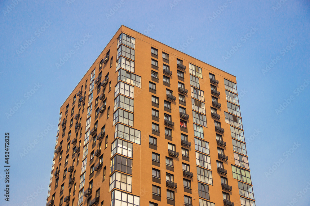 Modern brown multi-storey building against the sky