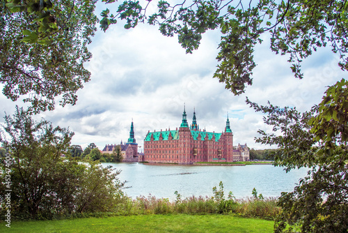 Obraz na płótnie magical fascinating landscape landscape with lake and largest renaissance castle in Scandinavia Frederiksborg slot Castle near Copenhagen. Hillerod, Denmark. Popular tourist atraction. w salonie