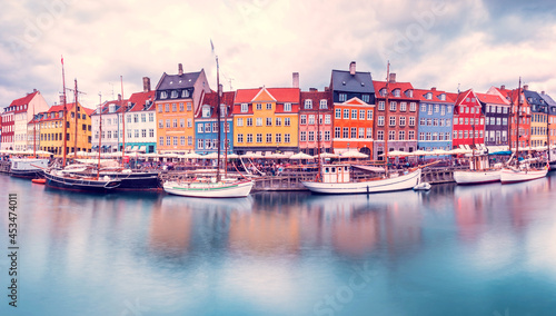 Unmatched magical landscape with boats in a famous place in the capital of Denmark Copenhagen – Nyhavn. Exotic amazing places. Popular tourist atraction.