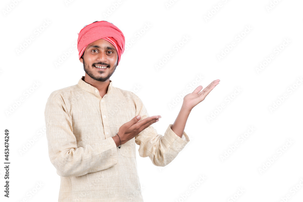 Young indian farmer standing on white background