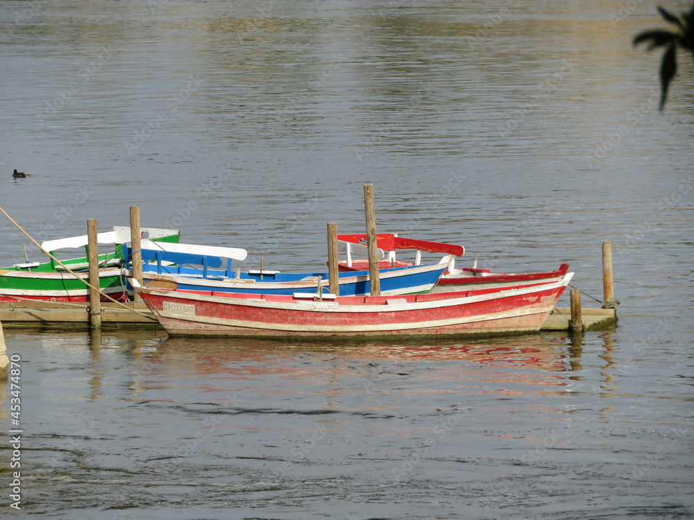 Naklejka premium beautiful boats colorful river water wood floating fun fishing