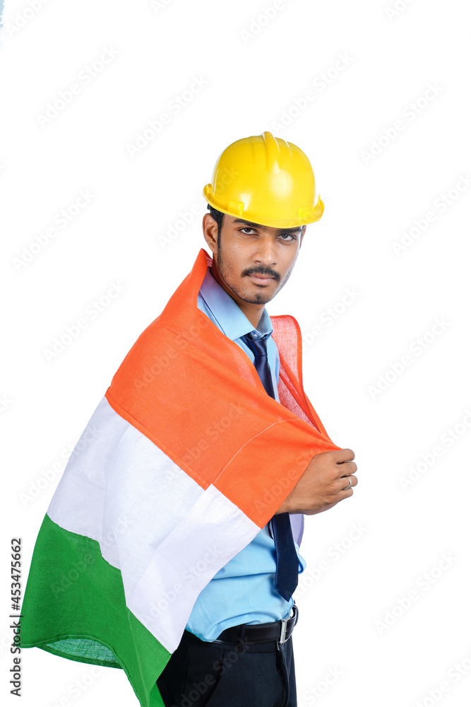 Young indian engineer in yellow color hard hat and waving national tricolor flag. Young indian engineer in yellow color hard hat and waving national tricolor flag.