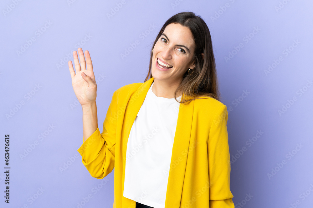 Young caucasian woman over isolated background saluting with hand with happy expression Young caucasian woman over isolated background saluting with hand with happy expression