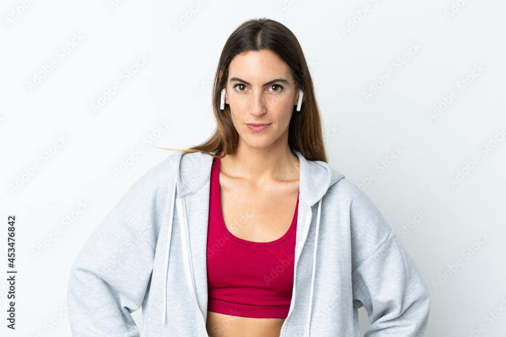 Young sport woman over isolated background posing with arms at hip Young sport woman over isolated background posing with arms at hip