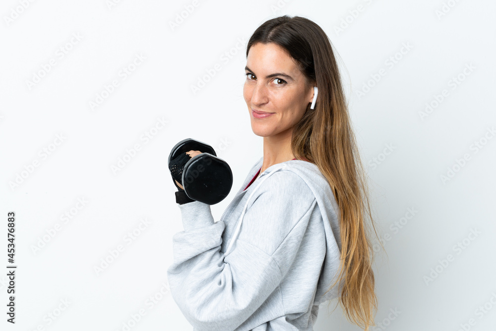 Fototapeta premium Young sport woman over isolated background making weightlifting