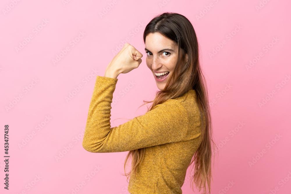 Young caucasian woman isolated on pink background doing strong gesture Young caucasian woman isolated on pink background doing strong gesture