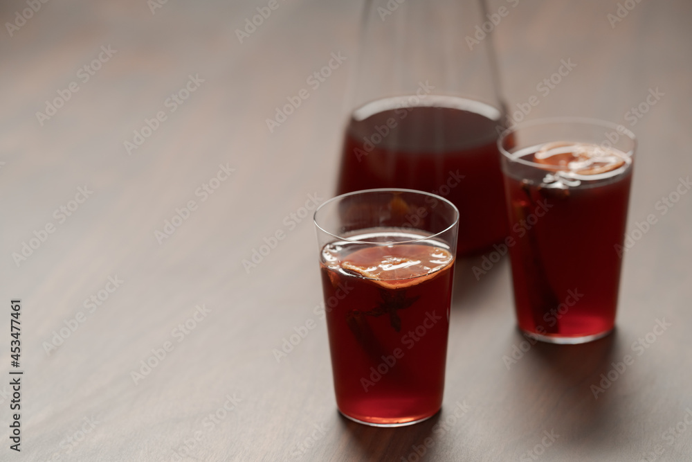 Mulled wine in tumbler glasses on walnut table with copy space Mulled wine in tumbler glasses on walnut table with copy space