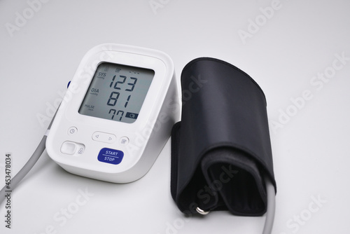 Close-up of digital blood pressure monitor with indicators of measurements on the screen. Digital Blood Pressure Monitor on white background.