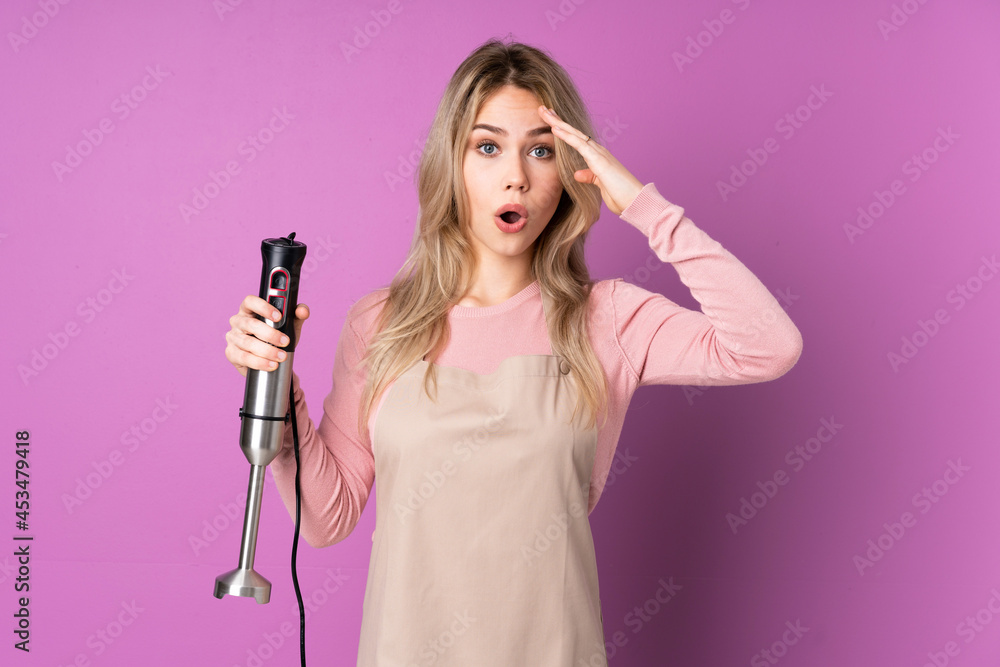 Teenager Russian girl using hand blender isolated on purple background has just realized something and has intending the solution Teenager Russian girl using hand blender isolated on purple background has just realized something and has intending the solution
