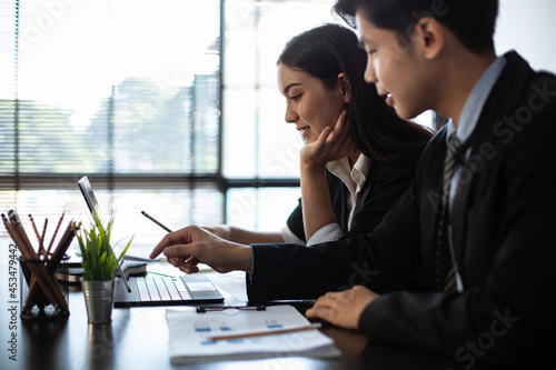 Young business people Are working together to analyze the current business in which direction to find profit in the business that started to invest. photo