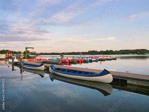 A quiet evening at Lake Unterbacher See in German city of Dusseldorf. Moored pedalos nad kayaks for rent. Beautiful landscape before the sunset © Lukasz