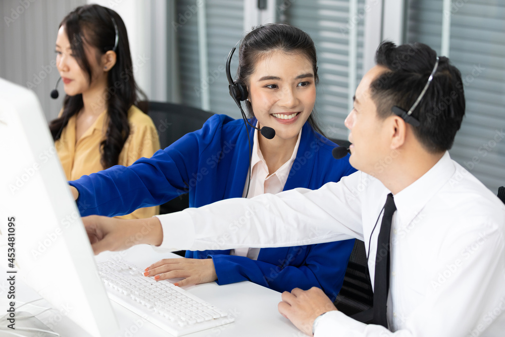 woman operator training and suggesting about work with colleagues at call center service woman operator training and suggesting about work with colleagues at call center service