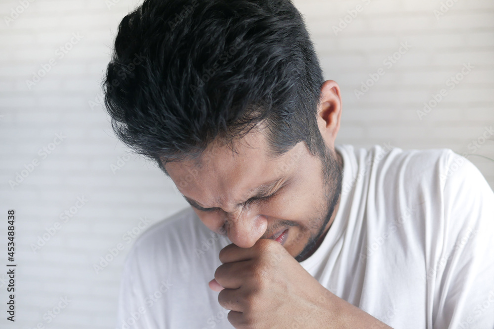 Fototapeta premium young sick man coughing and sneezes 