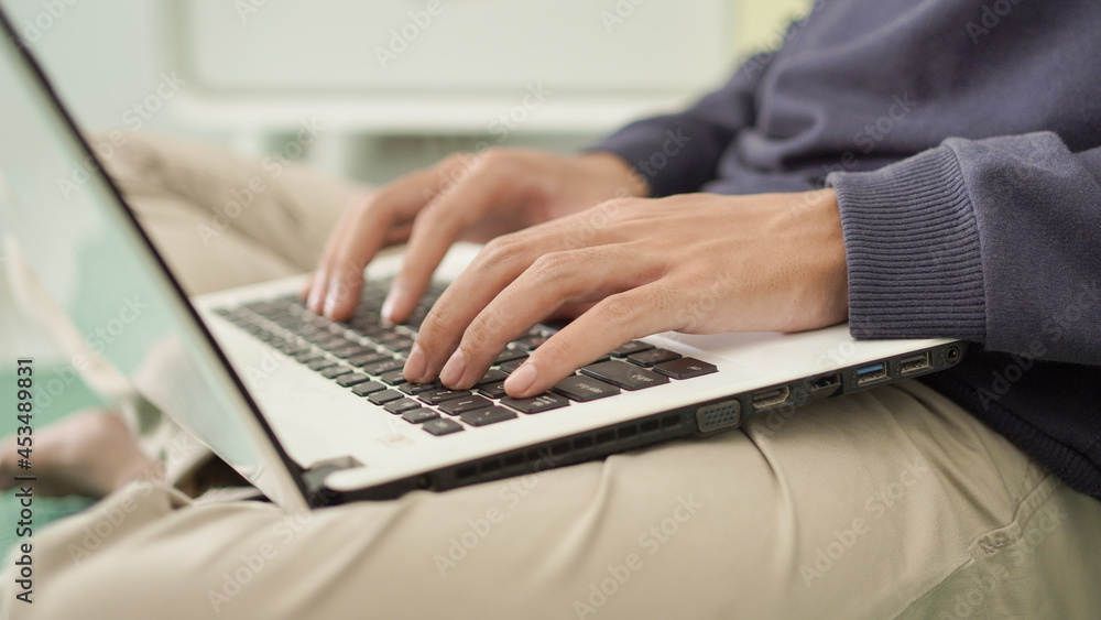 handsome asian man typing laptop at home handsome asian man typing laptop at home