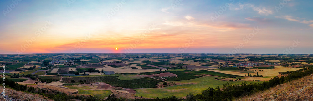 Stunning sunset. Panoramic view of the vineyards and other crops in the Ribera del Duero, where delicious wines are made. In Castilla y Leon, Spain.