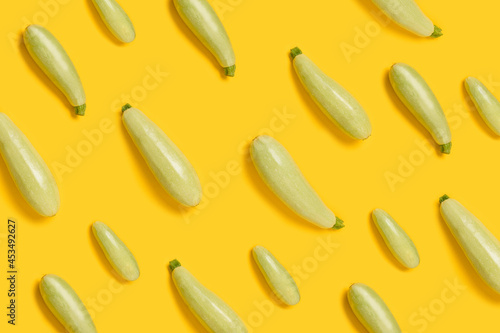 Flat lay composition with fresh organic vegetable marrow on yellow color background