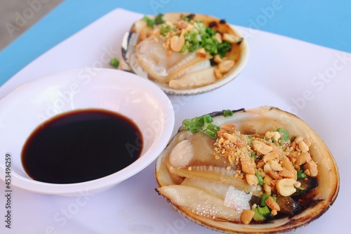 Grilled Scallop. Seafood with spicy sauce.