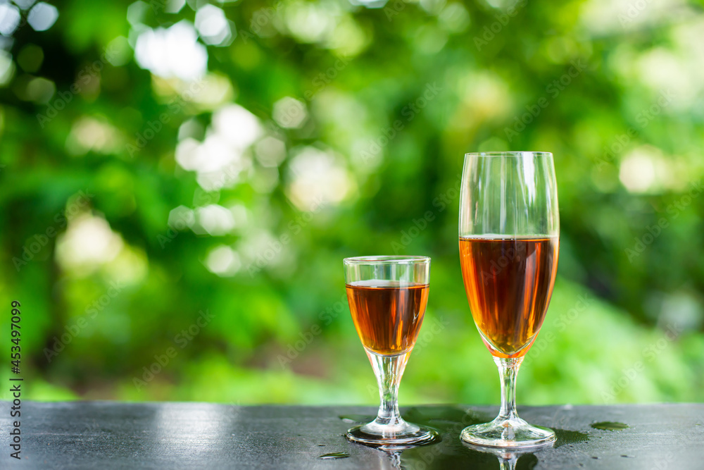 Red wine in small and large glasses placed on the bar. Red wine in small and large glasses placed on the bar.