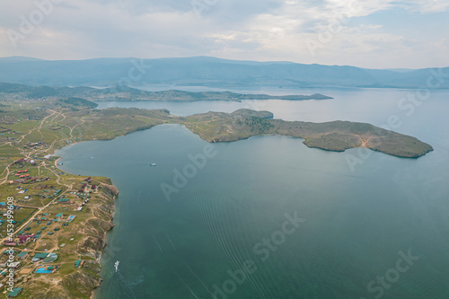 A ferry from the east coast to Olkhon Island Khuzhir at sunrise. Lake Baikal. From the side of the island.