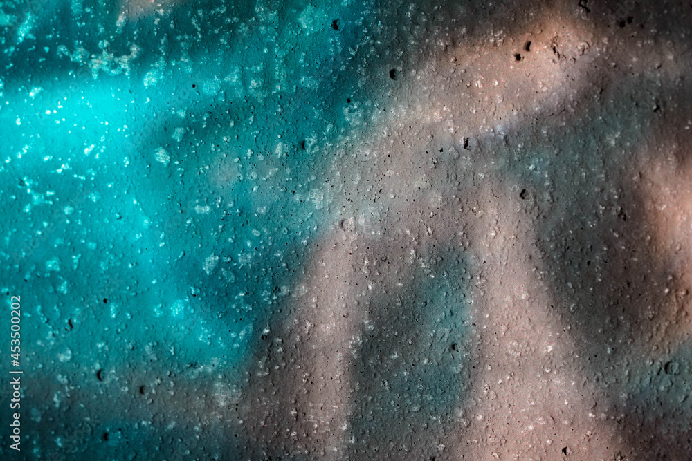 Fototapeta premium Glass reflections on a textured wall which can be used as background, texture, portrait backdrop, packaging, graphic, advertisement or design elements