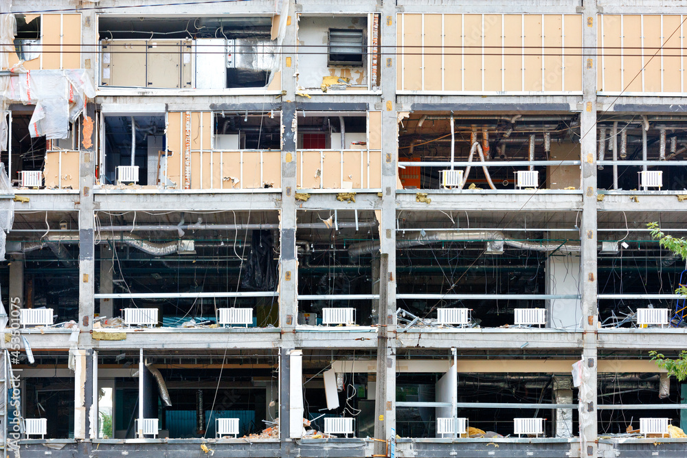 Opened, destroyed facade of a commercial modern building to be reconstructed.