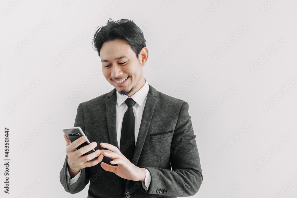 Happy smile face of Asian businessman use smartphone in concept of trading app. Happy smile face of Asian businessman use smartphone in concept of trading app.