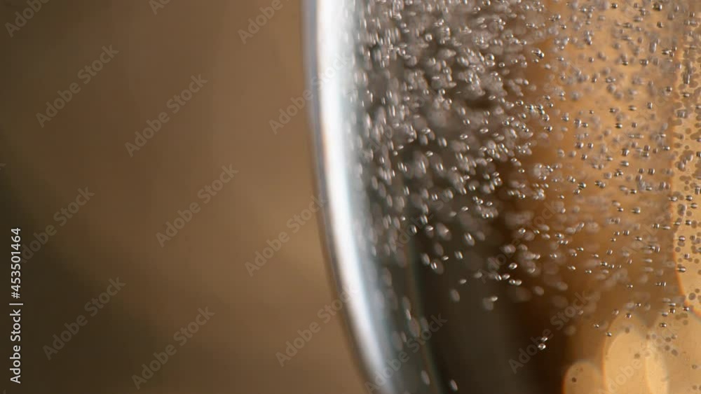 Super slow motion of pouring Champagne wine into glass, closeup view. Filmed on high speed cinema camera, 1000fps Super slow motion of pouring Champagne wine into glass, closeup view. Filmed on high speed cinema camera, 1000fps