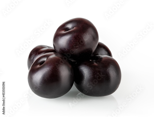 Pyramid of ripe juicy whole black plums isolated on white background. Ready to eat fresh ripe sweet plums. Design element for vegetarian, vegan and vitamin healthy eating. High quality image.