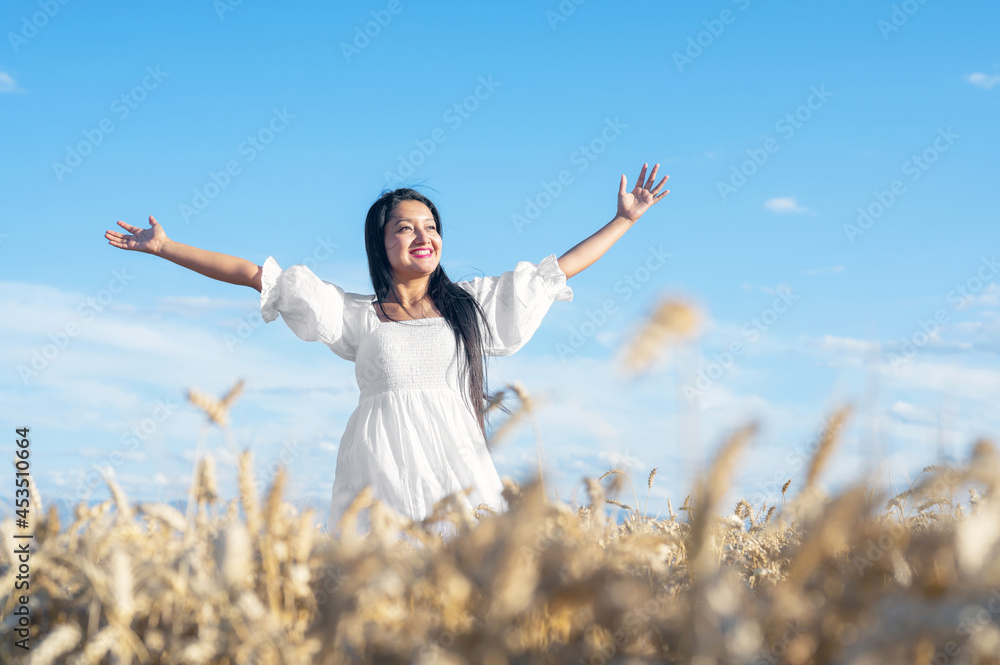 Portrait of happy young woman in a white dress, on a wheat field. Lifestyle and happiness concept. Woman with open arms . High quality photo Portrait of happy young woman in a white dress, on a wheat field. Lifestyle and happiness concept. Woman with open arms . High quality photo