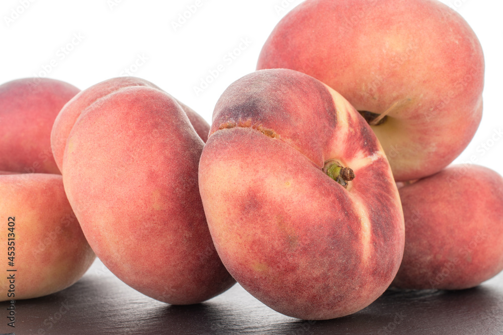 Several juicy organic peaches on a slate stone, close-up, isolated on white. Several juicy organic peaches on a slate stone, close-up, isolated on white.