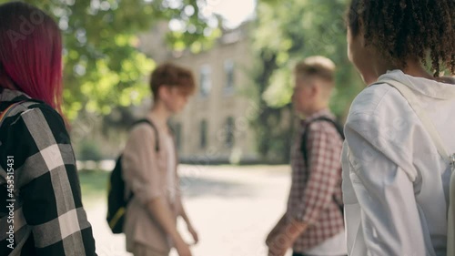 Classmates instigating fight between two angry school boys, bullying problem photo