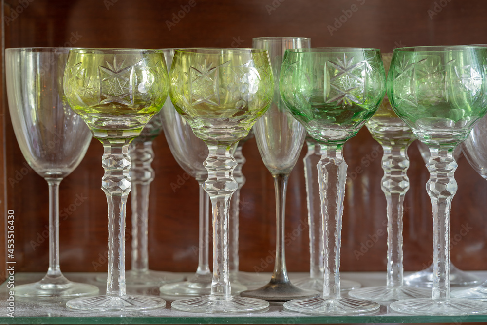 Crystal glasses in an old sideboard. August 2021. - obrazy, fototapety, plakaty 
