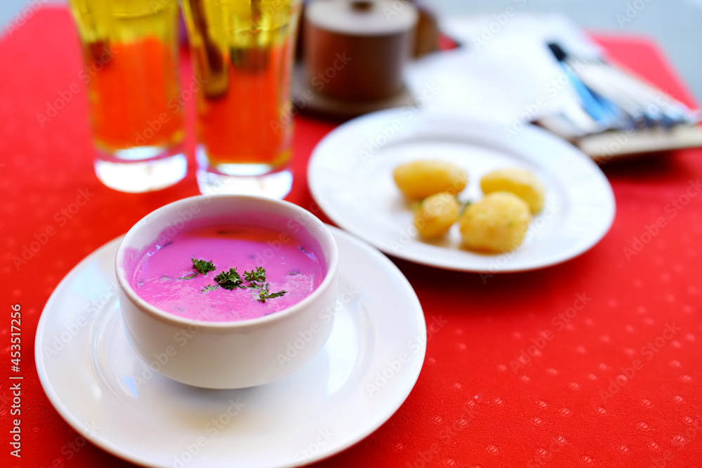 Lithuanian cold beet soup called saltibarsciai. Bright pink soup made of beetroots and kephir and served with boiled potatoes. Tradicional Lithuanian cuisine. Lithuanian cold beet soup called saltibarsciai. Bright pink soup made of beetroots and kephir and served with boiled potatoes. Tradicional Lithuanian cuisine.