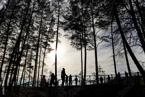 Silhouettes of people enjoying the view of Vilnia river and geological Puckoriai exposure in Vilnius, the highest exposure in Lithuania.