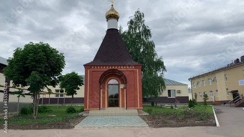 Small chapel on a cloudy day top-down view against a gray sky with clouds