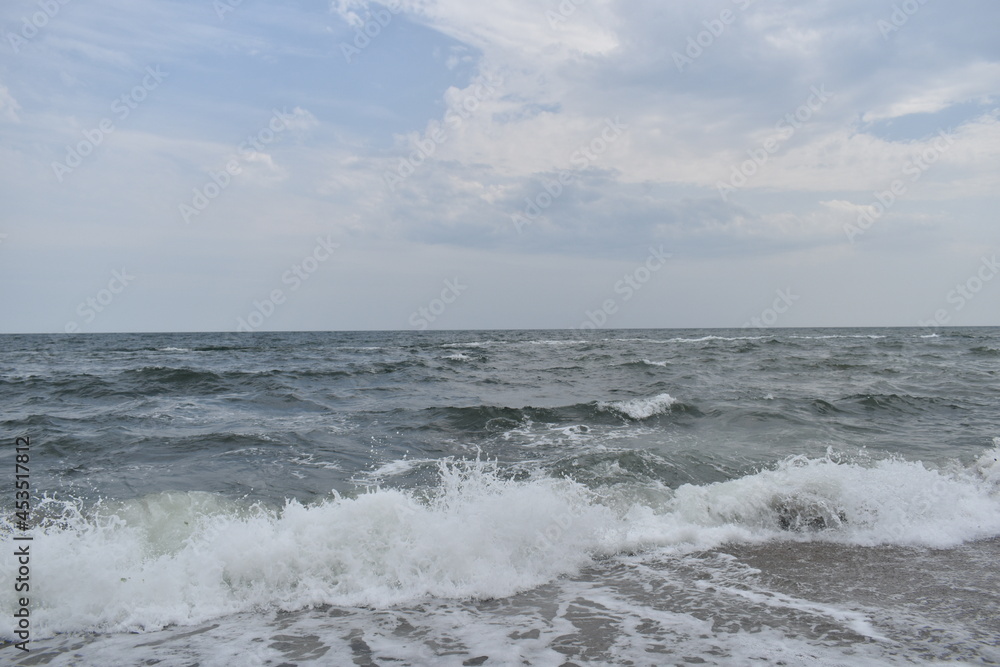 white foam from the waves on the black sea