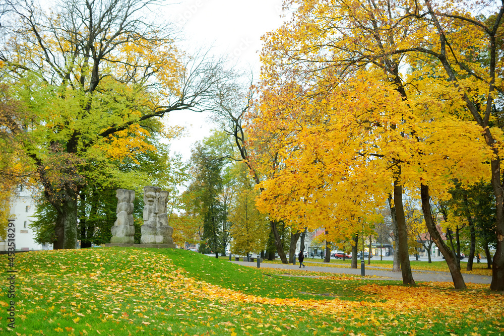 Colorful city park scene in the fall with yellow foliage. Beautiful autumn scenery in Vilnius, Lithuania Colorful city park scene in the fall with yellow foliage. Beautiful autumn scenery in Vilnius, Lithuania
