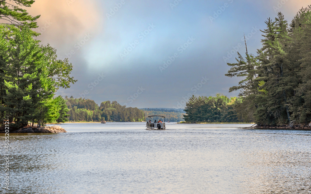 People are enjoying fishing and boating under sunset on Crane Lake, Voyageurs National Park, Minnesota