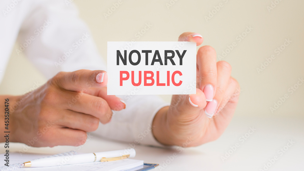 'notary public' card in the woman's hands. Business, Ethics, Advertising, Marketing. 'notary public' card in the woman's hands. Business, Ethics, Advertising, Marketing.