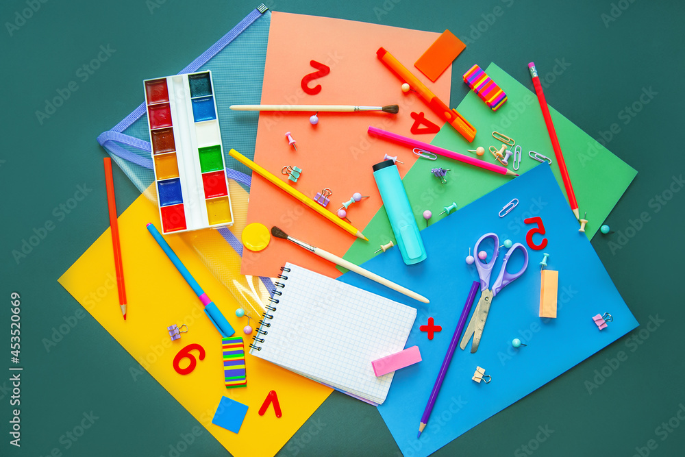 Office supplies are scattered on a table or a blackboard. Back to school. Flat lay. Copy space.