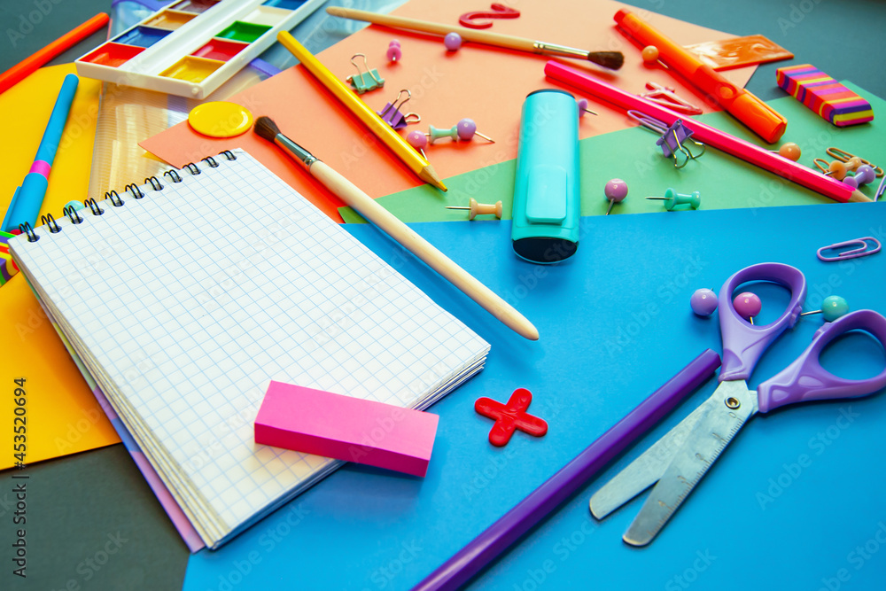 Office clutter. Colorful stationery is scattered on the table. Back to school. Office clutter. Colorful stationery is scattered on the table. Back to school.