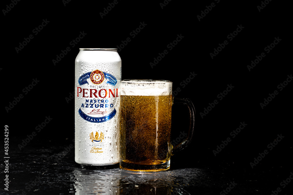 Can of Peroni Nastro Azzurro beer and beer glass on dark background Stock  Photo