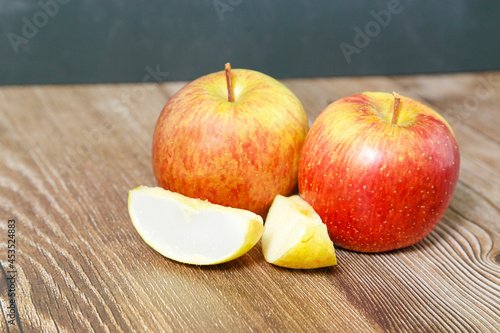 Apples seen from above with two pieces on wooden table