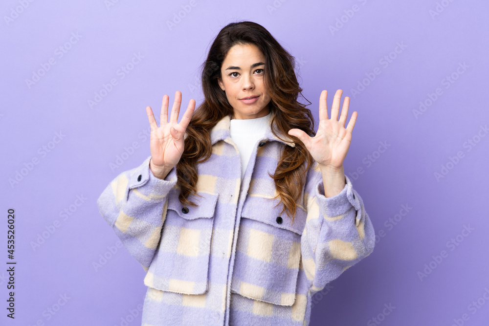 Woman over isolated purple background counting nine with fingers Woman over isolated purple background counting nine with fingers